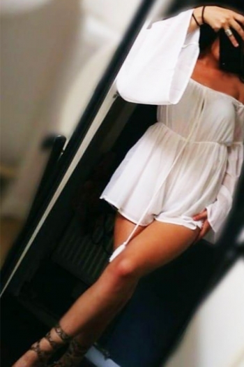 Jessica standing in a white dress 